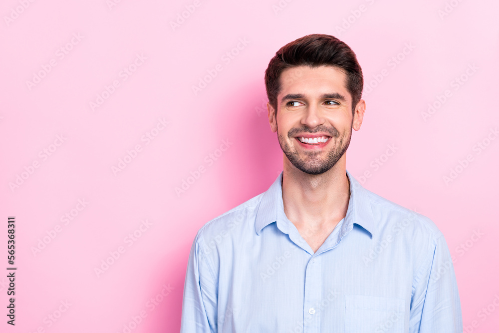 Portrait of positive man interested look empty space announcement nice offer seasonal sale special deal isolated on pink color background Portrait of positive man interested look empty space announcement nice offer seasonal sale special deal isolated on pink color background
