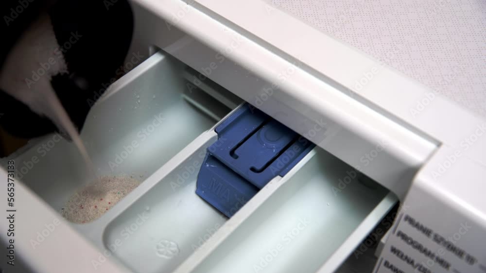 Pours the washing powder into the tray of the automatic washing machine. Preparation for washing. Pours the washing powder into the tray of the automatic washing machine. Preparation for washing.