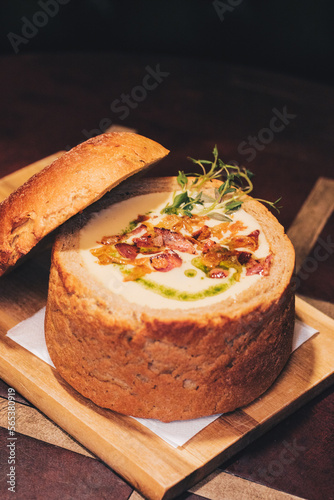 Delicious cream soup with bacon in bread