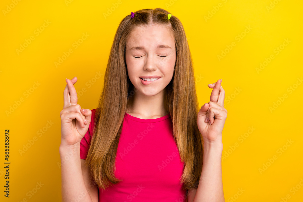 Photo of young teenager girl wearing pink crop top crossed fingers closed eyes nervous pleading stressed request isolated on yellow color background Photo of young teenager girl wearing pink crop top crossed fingers closed eyes nervous pleading stressed request isolated on yellow color background