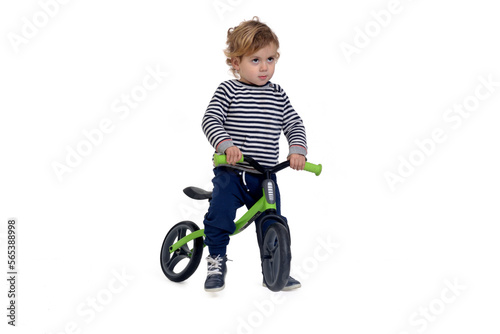  baby who rides a bike standing on white background
