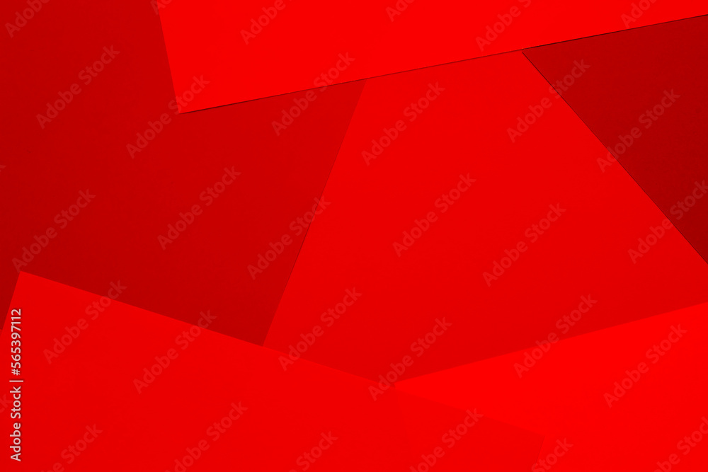 Fototapeta premium Sheets of colored paper in red shades as a background. Mockup, copy space. Geometric print.