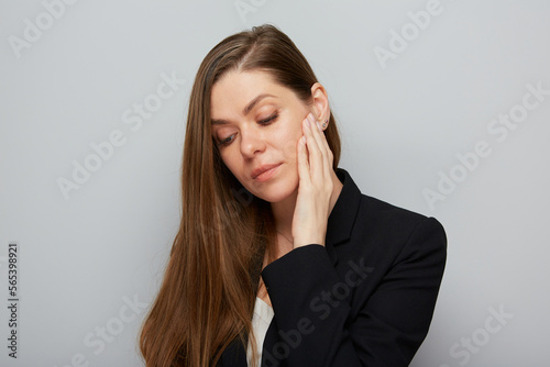 Serious thinking business woman touching her face looking down Isolated portrait.