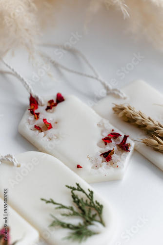 Aroma sachet with dried flowers with coconut or organic soy wax. Close up on white background