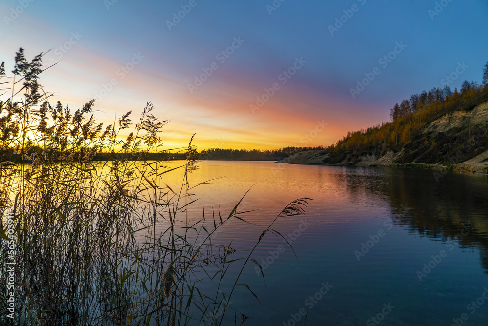 Beautiful sunset on the lake in the late evening .