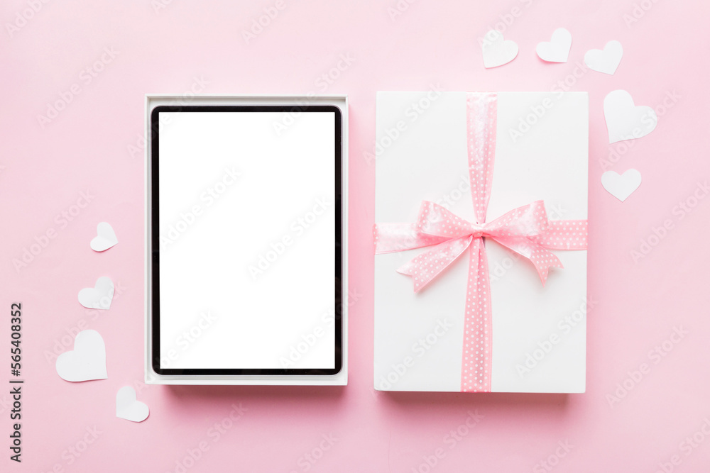 Gift box of open tablet for the holidays with a bow top view
