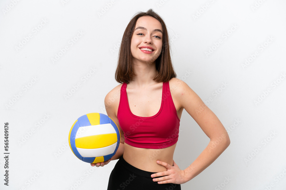 Young Ukrainian woman playing volleyball isolated on white background posing with arms at hip and smiling Young Ukrainian woman playing volleyball isolated on white background posing with arms at hip and smiling