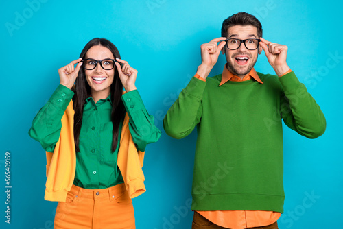Photo of amazed shocked professional workers guy lady touch specs optics sale isolated on blue color background