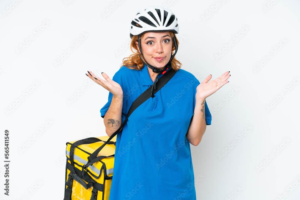 Young caucasian woman with thermal backpack isolated on white background having doubts while raising hands Young caucasian woman with thermal backpack isolated on white background having doubts while raising hands