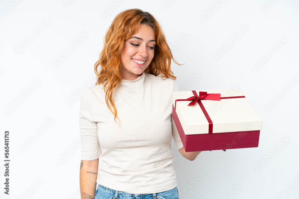 Young caucasian woman holding a gift iso0lated on white background with happy expression Young caucasian woman holding a gift iso0lated on white background with happy expression