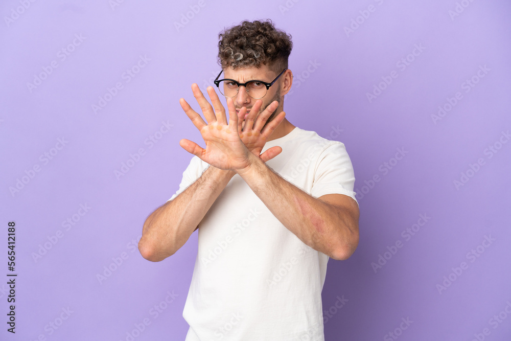Delivery caucasian man isolated on purple background nervous stretching hands to the front Delivery caucasian man isolated on purple background nervous stretching hands to the front