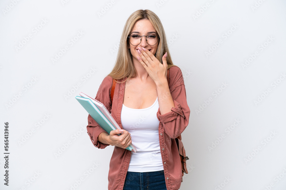 Pretty student blonde woman isolated on white background happy and smiling covering mouth with hand Pretty student blonde woman isolated on white background happy and smiling covering mouth with hand
