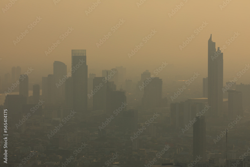 Naklejka premium Panoramic view of the skyline of Bangkok, Thailand, at sunset, with its skyscrapers, plunged in pollution, from the observation deck of the Baiyoke Tower II