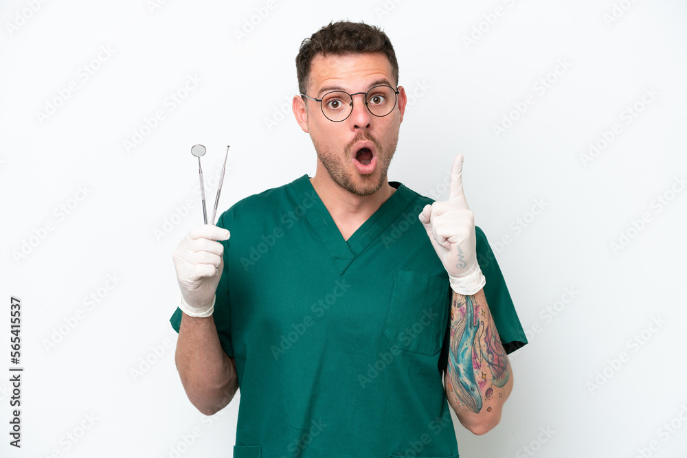 Young caucasian dentist man isolated on white background intending to realizes the solution while lifting a finger up Young caucasian dentist man isolated on white background intending to realizes the solution while lifting a finger up