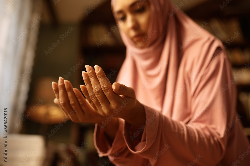 Close up of Muslim woman during her prayer at home.