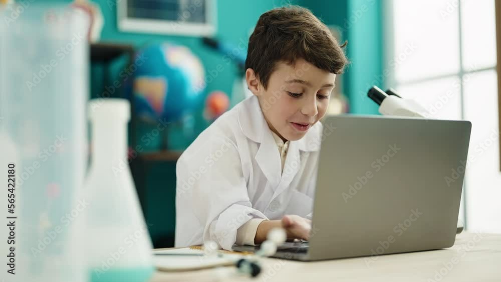 Adorable hispanic boy student having video call at laboratory classroom Adorable hispanic boy student having video call at laboratory classroom