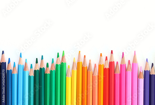 Colour pencils isolated on white background. Uneven rainbow.