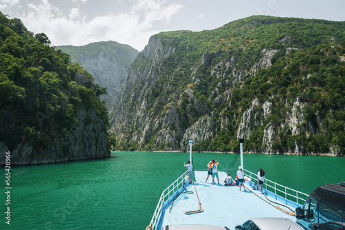 View from the ferry on Lake Komani. A tourist boat overtakes the car ferry on Komani Lake in the dinaric alps of Albania