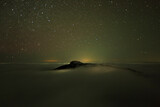night scene with stars and sea of clouds in Ceahlau mountain, Romania