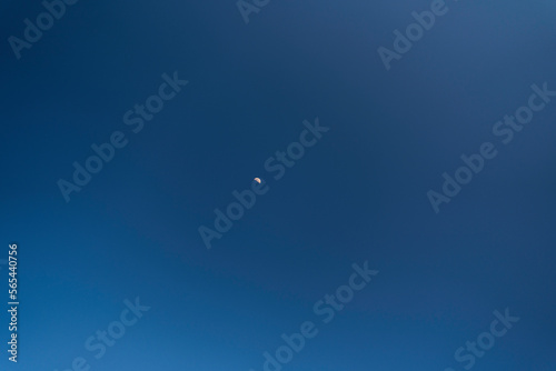 big full moon over cloud free blue sky