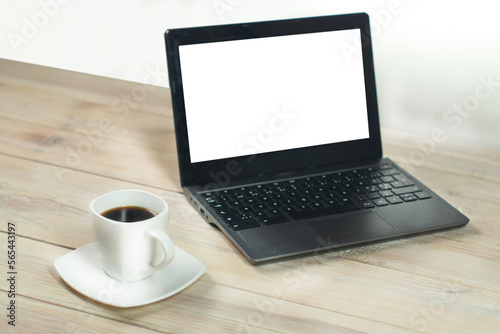 a cup of coffee next to a laptop