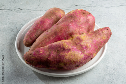 Raw sweet potato on the table.
