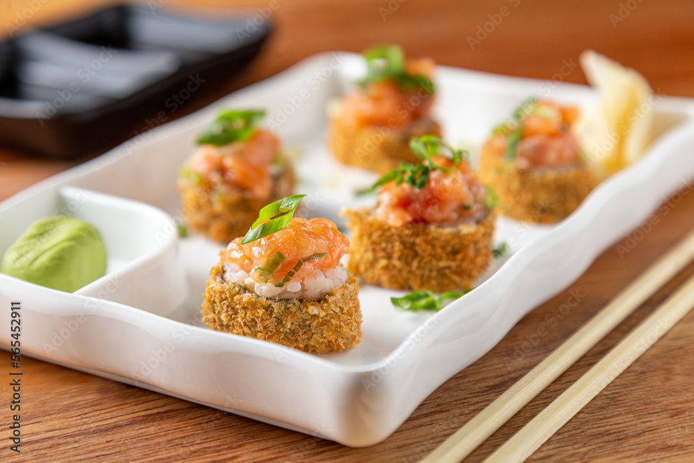 Sushi rolls on the wooden table.