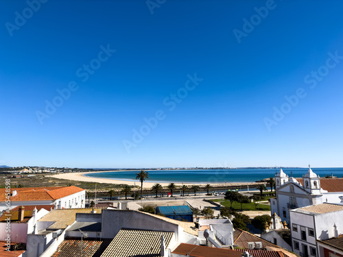 Old town in the center of Lagos, Algarve region, Portugal. Showing beach with blue skies