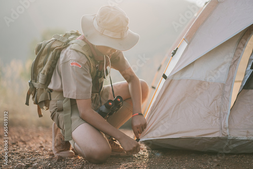 Asian boy scouts spreading adventure camping tent photo