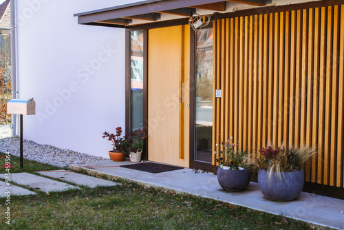 Fototapeta Entrance to the house, vertical wood panels, glass doors to the floor, large flo