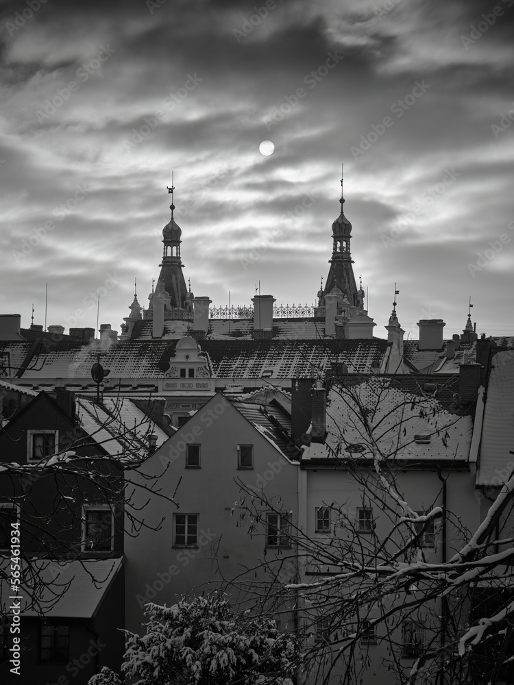 The sun behind the clouds between two towers in black and white, Pardubice, Czech Republic