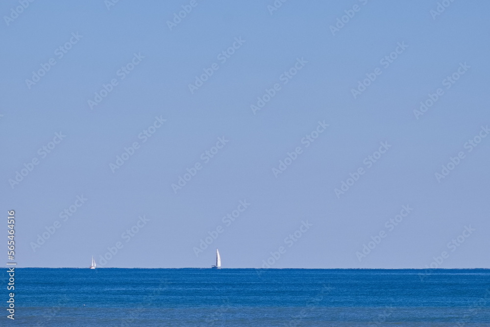Nice seascape with boats going through the surf in vacation time	
