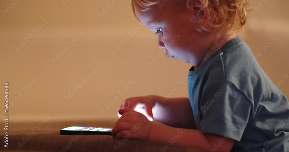 Small Baby pressing and scrolling with finger on phone touch screen ...