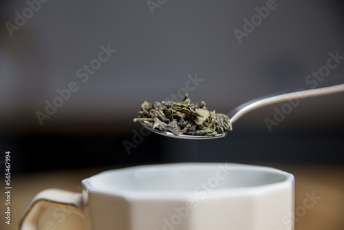 adding green tea to the cup