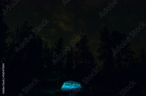 Starry night sky over lantern-lit tent