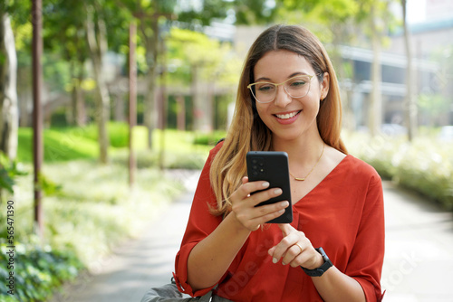 Portrait of Brazilian woman using mobile phone in Sao Paulo sustainable metropolis