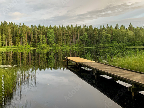Fotografie Long wooden jetty by a small lake