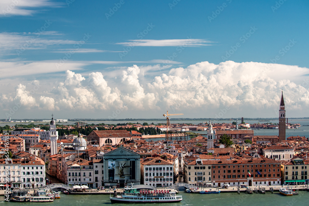 Crowded Venice seen from the top of the church tower. Unique image captured summer with a blue sky with clouds