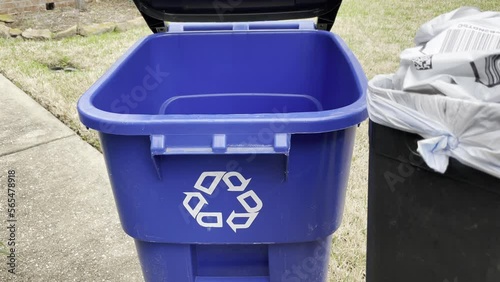 Man taking recyclables out to the recycling bin.