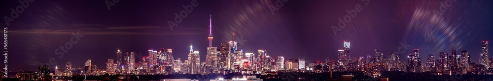 Toronto skyline at night with buildings street lights. Toronto, Ontario, Canada. Down town city skyline and panorama with urban areas. Sky with lights leaks.