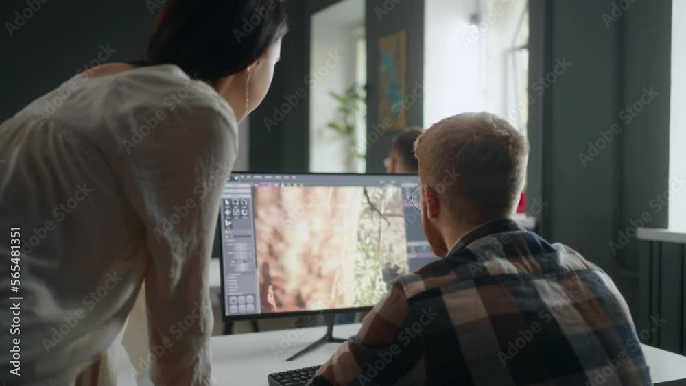 video game developers creating new interface in office, man and woman discussing level design video game developers creating new interface in office, man and woman discussing level design