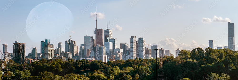 Fototapeta premium Full moon over Toronto at morning blue sky. Toronto, Ontario, Canada skyline and moonlight of full moon. Cityscape with rising moon over GTA center. Great Toronto Area night city view.