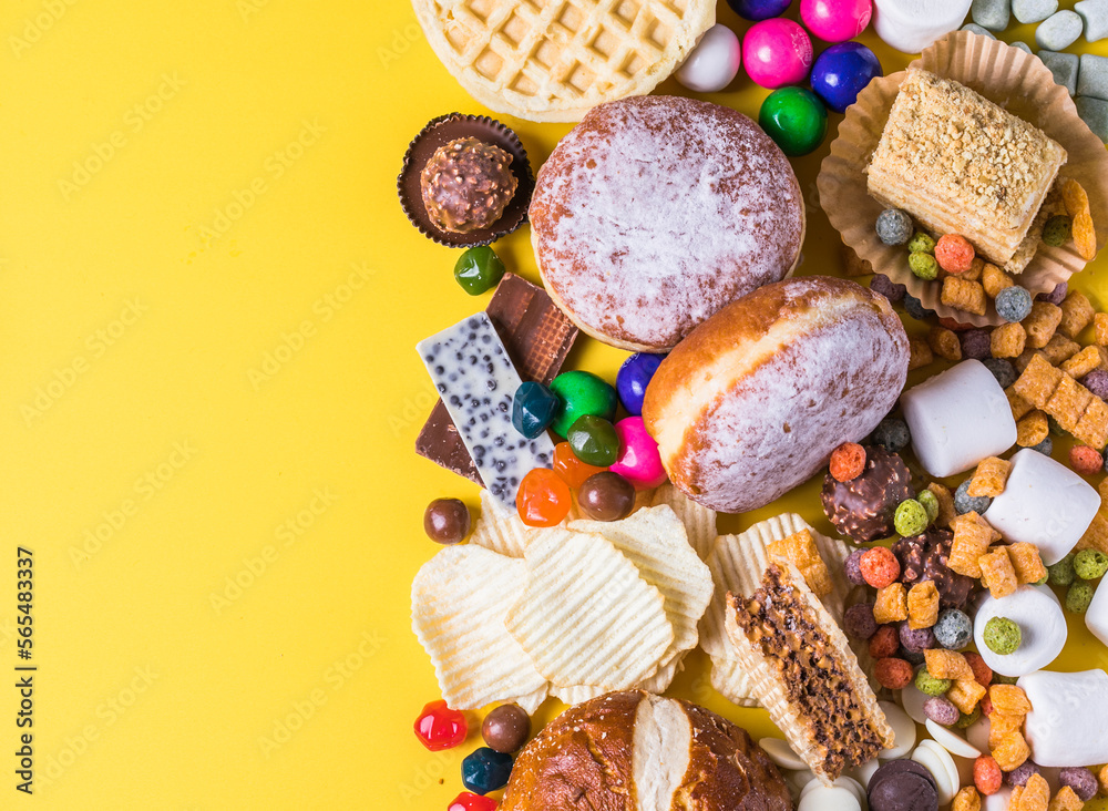 .An assortment of unhealthy foods that are bad for the figure, skin, heart and teeth. Fast carbohydrate food. Space for text .An assortment of unhealthy foods that are bad for the figure, skin, heart and teeth. Fast carbohydrate food. Space for text