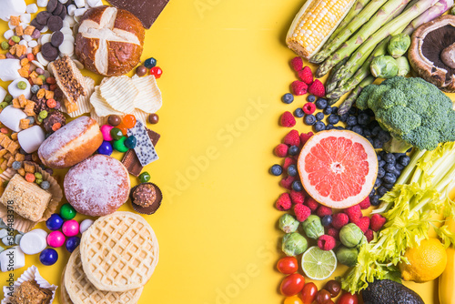 The concept of healthy and unhealthy food. Top view of fast food and sweets - fruits and vegetables