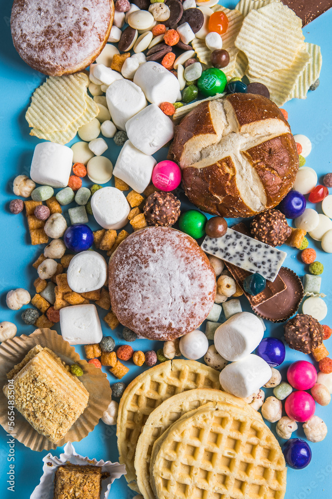 Fototapeta premium .An assortment of unhealthy foods that are bad for the figure, skin, heart and teeth. Fast carbohydrate food. Space for text