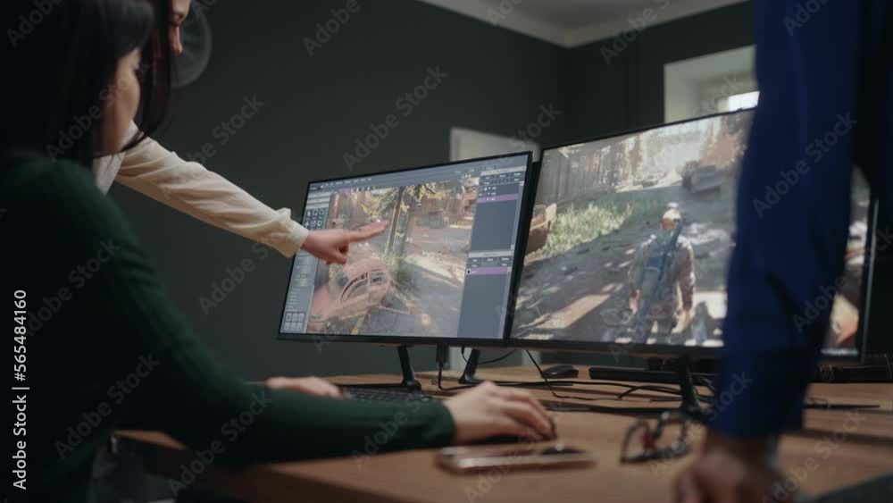 group of women in office of video game design company, IT specialists discussing