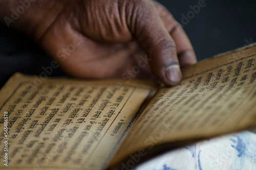 Hindu man reading ancient scripturesÂ IndreshwarÂ MahadevÂ Temple in city ofÂ Panaut photo