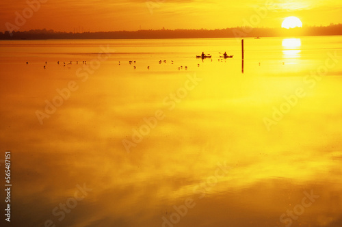 Two people kayaking at sunset on Arcata Bay, Northern California. photo