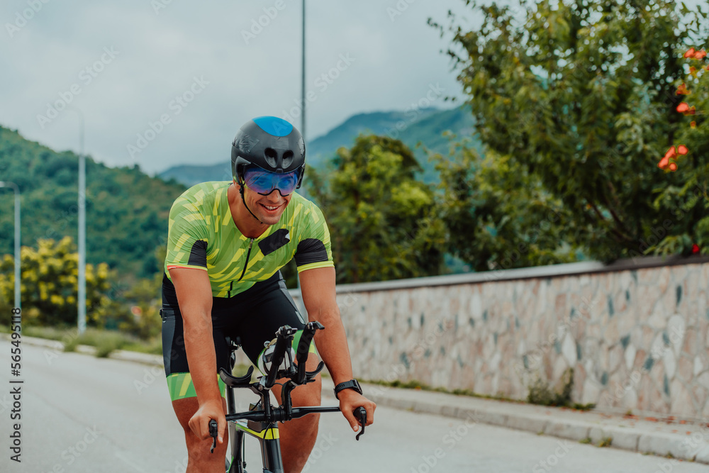 Full length portrait of an active triathlete in sportswear and with a protective helmet riding a bicycle. Selective focus Full length portrait of an active triathlete in sportswear and with a protective helmet riding a bicycle. Selective focus