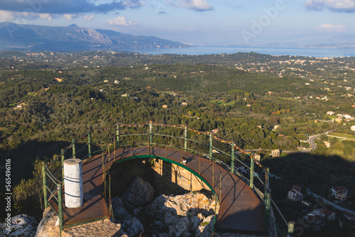 View of Kaiser's Throne observation deck lookout, Pelekas village, Corfu island, Greece, Kaiser William II summit Observatory panoramic summer view with mountains and Kerkyra in the background photo